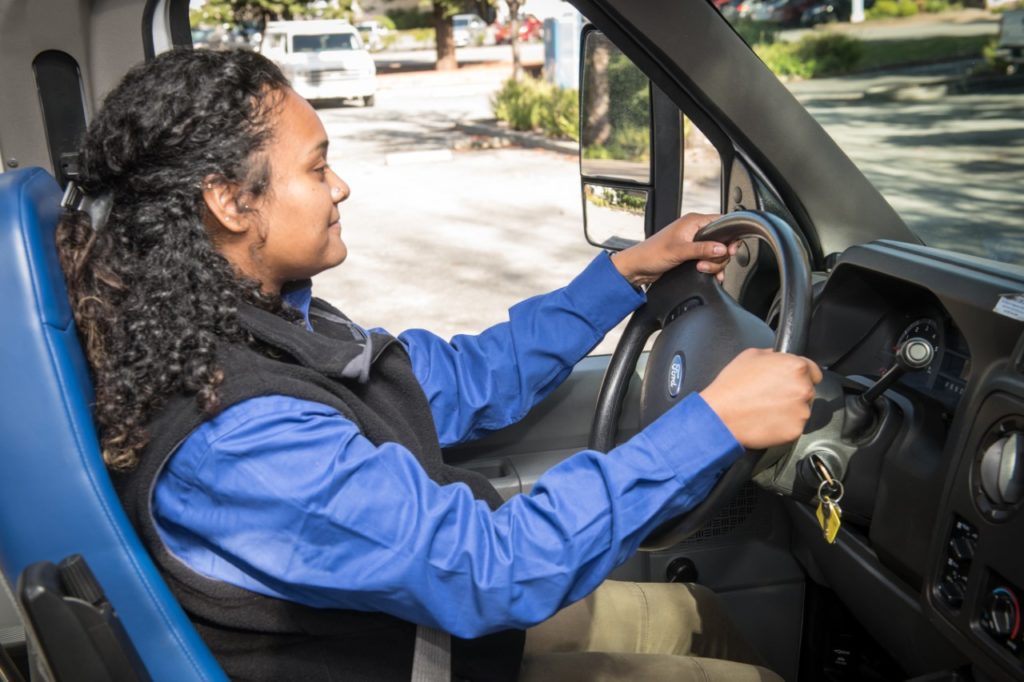 Female driver behind the wheel of bus