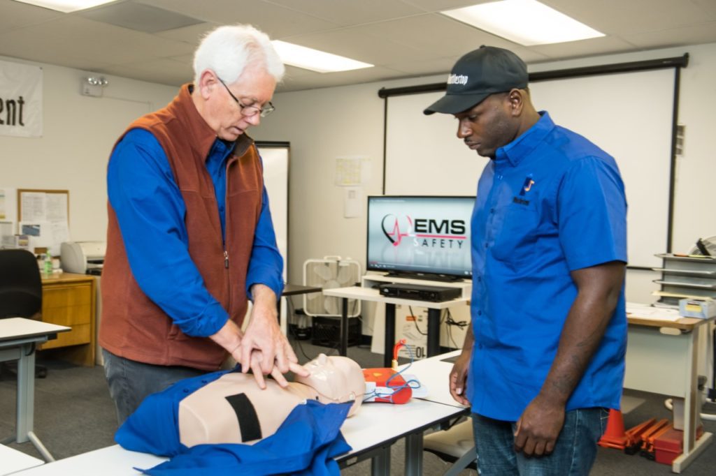 Driver and instructor with CPR doll