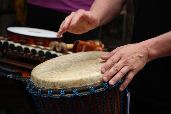 hands playing a hand drum